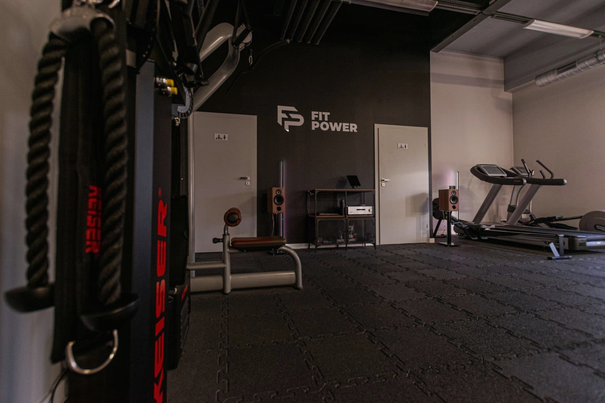 Wnętrze studia FitPower ze ścianą z logo